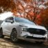 a white suv driving down a dirt road